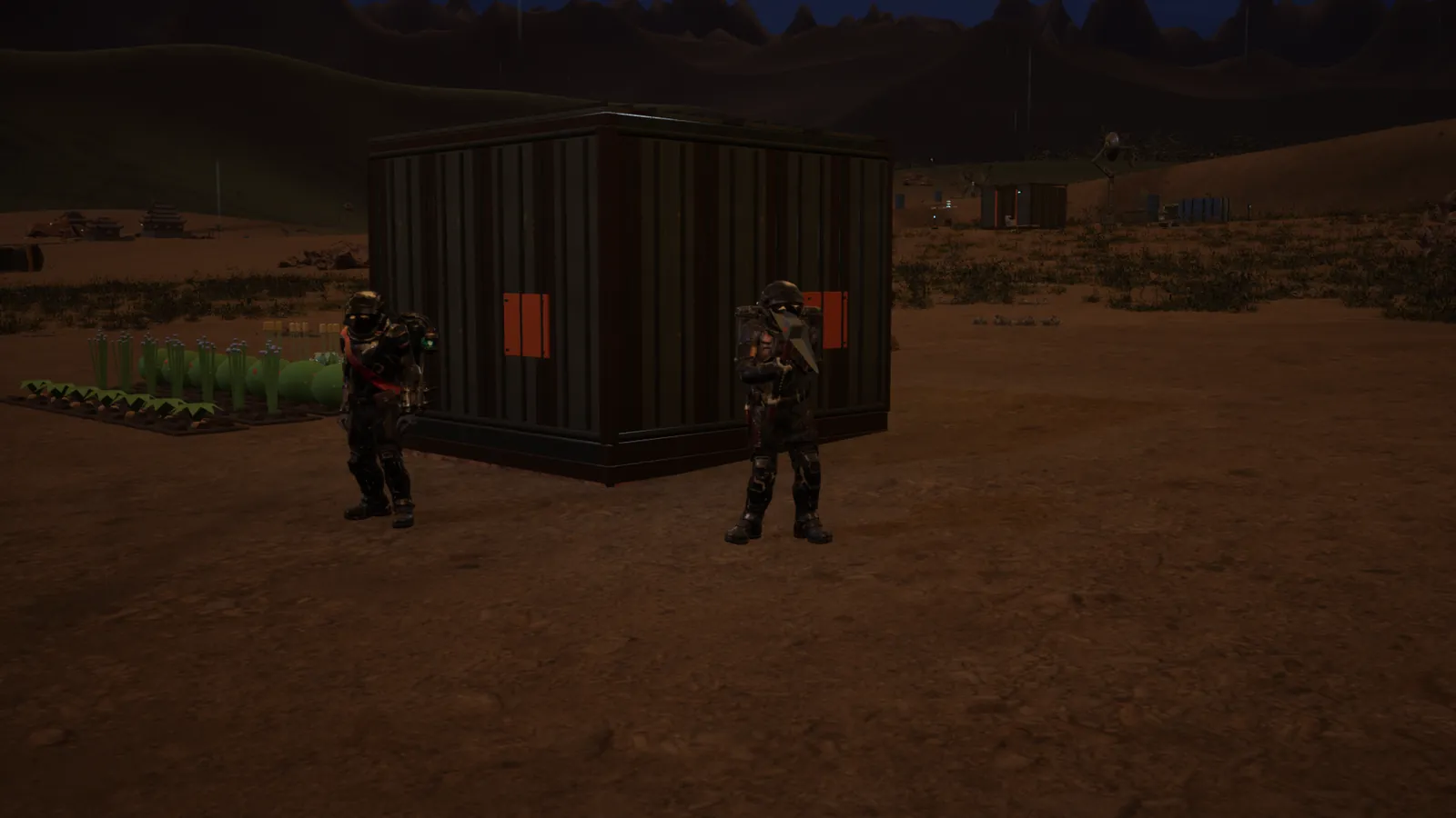 Two explorers by the shelter at night, crops behind them
