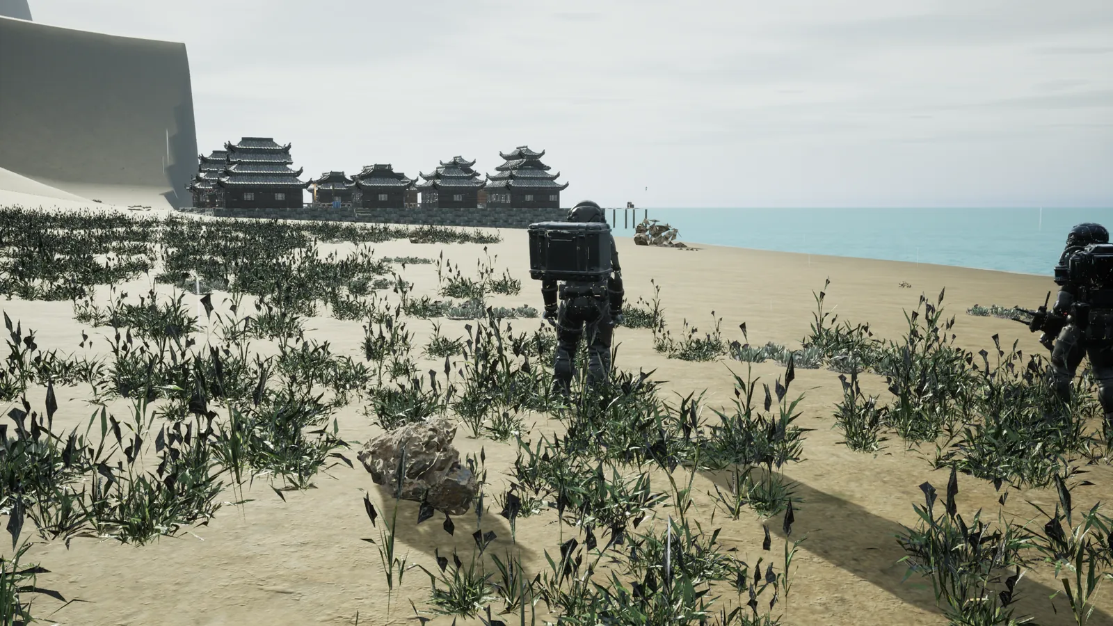 Two explorers cross beach grass toward the sea, with the waterfront village behind
