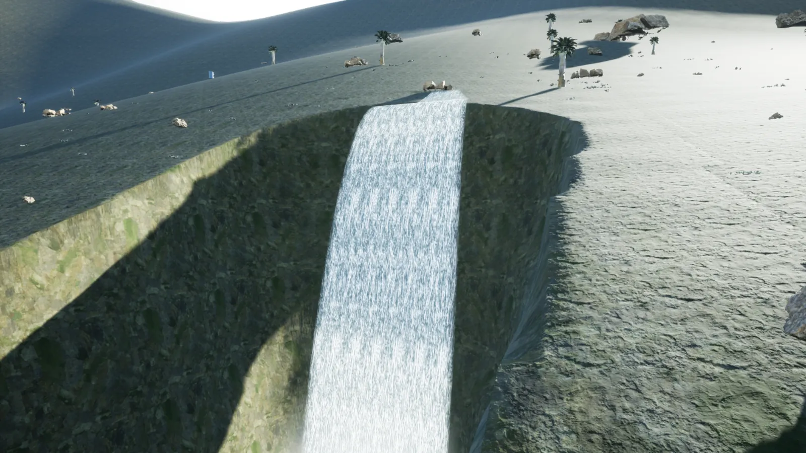 A waterfall pours into a canyon cut through grassy ground